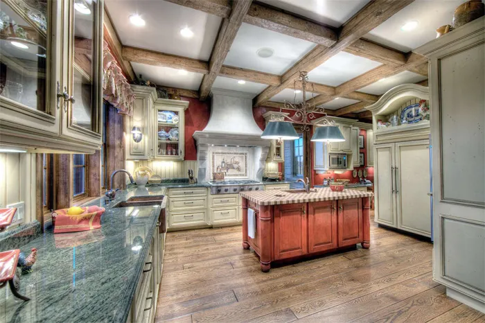 Grand custom kitchen with a coffered beam ceiling and tiled range alcove