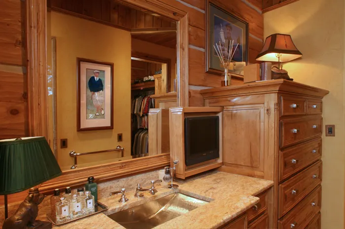 Bedroom built-ins with a media cabinet, dresser, and granite top
