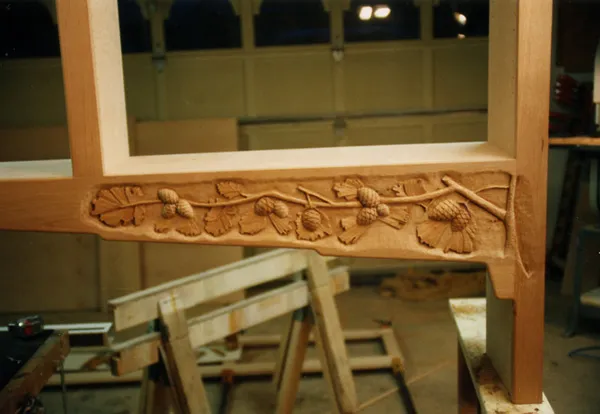 Hand-carved apron detail under construction in the workshop
