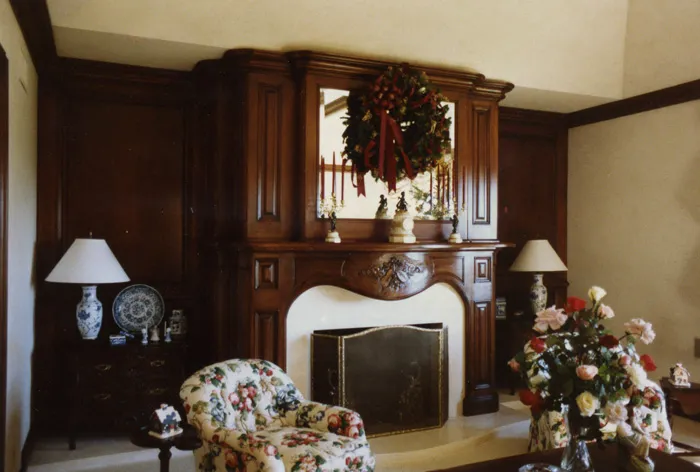 Formal living room with a dark-wood built-in entertainment wall and fireplace