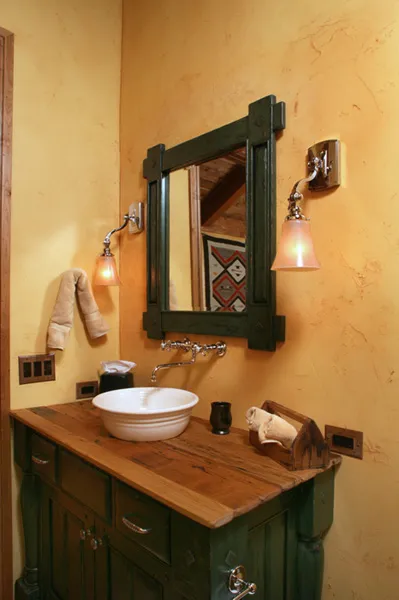 Custom vanity with a green-framed mirror and vessel sink