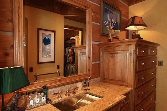 Knotty alder kitchen with a large granite island and custom range hood