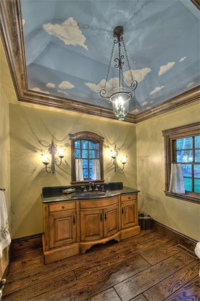 Powder room with a custom alder vanity beneath a hand-painted sky ceiling