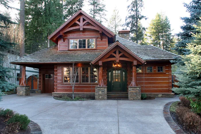 Custom timber-frame home exterior nestled in the North Idaho pines