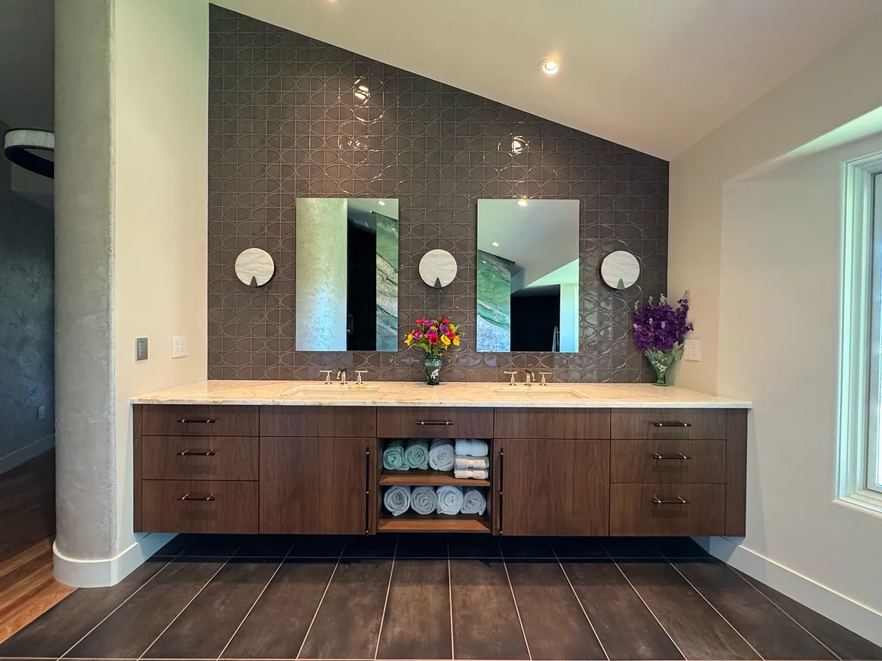 Contemporary floating double vanity in walnut with a patterned tile feature wall