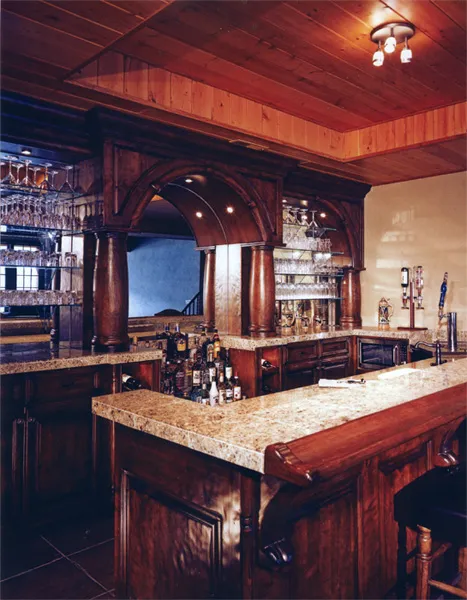 Richly paneled custom bar and kitchen in warm-stained hardwood